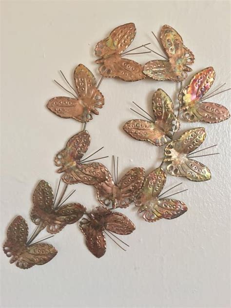A Bunch Of Butterflies That Are Hanging On The Side Of A Wall In A Circle