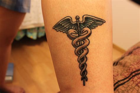 Having a tattoo it makes sense that you are starting to see tattoos becoming more common in the healthcare field. Nursing symbol Tattoos