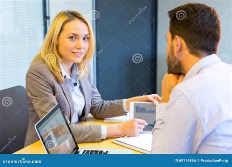 Young Attractive Woman During Job Interview Using Tablet Stock Photo