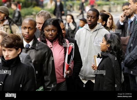 Job seekers line up for a job fair sponsored by Monster.com in New York