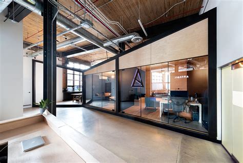 The open space with the workplaces is the basis of the office. Office for Visual Effects Studio Combines Industrial Style ...
