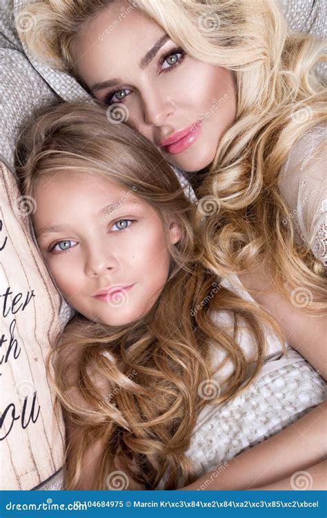 Portrait Of The Beautiful Blonde Woman Mother And Daughter On The