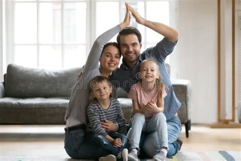 Happy Spouses Having Fun With Small Kids Making Love Sign Stock Photo