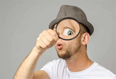 Premium Photo Astonished Man Looking Through A Magnifying Glass