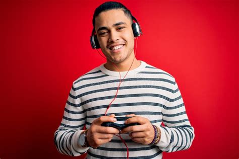 Brazilian Gamer Woman Playing Video Game Using Headphones Over Isolated