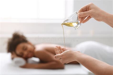 Woman Therapist Applying Massage Oil On Hands Before Therapy Stock
