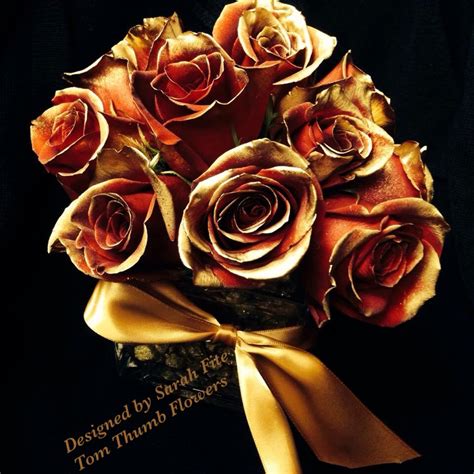 As complementary colors, these flowers represent the long life of two people who have come together to support and complement one another. Floral Arrangement with gold roses and stones perfect for ...
