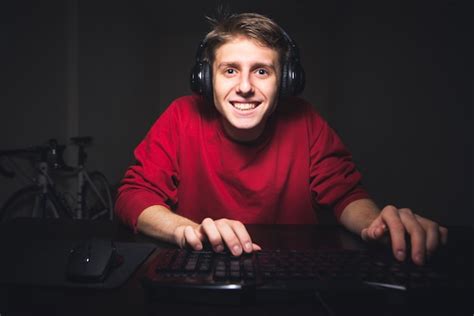 Premium Photo Happy Young Gamer Looks At The Computer Monitor And