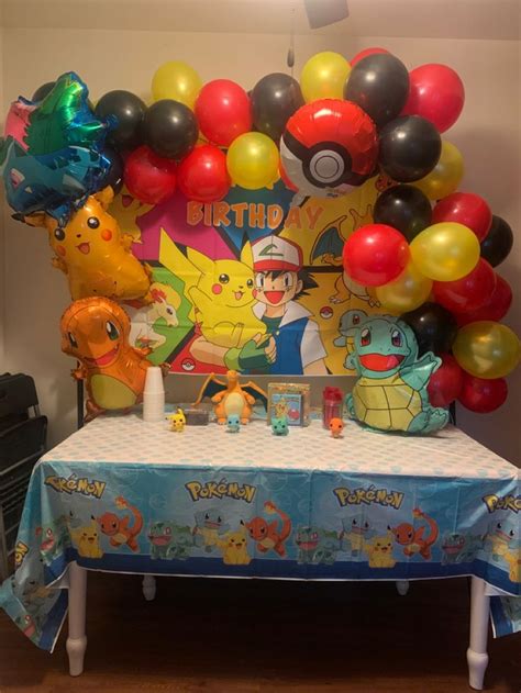 A Pokemon Themed Birthday Party With Balloons And Streamers On The Head