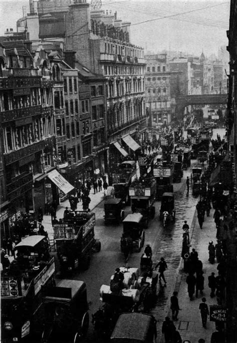 An Old Black And White Photo Of A City Street With Cars Trucks And People
