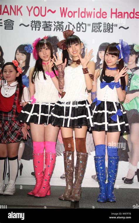 members of japanese pop idol girl group morning musume wave at a handshake event to thank fans