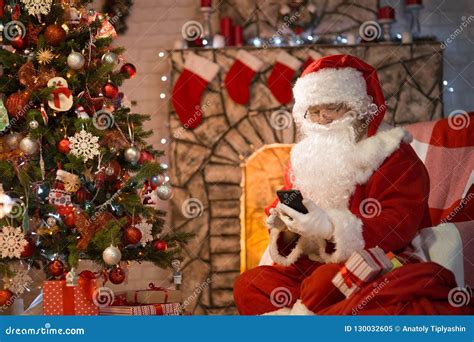 Merry Christmas Santa Claus At Home By The Fireplace And Christ Stock