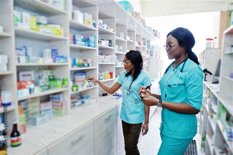 Two African American Pharmacist Working In Drugstore At Hospital