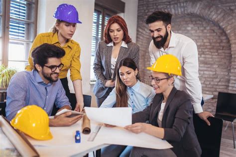 Meeting The Team Of Engineers Working On A Construction Project Stock