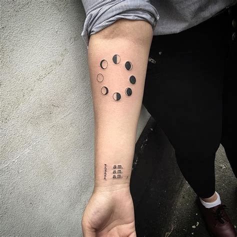 Circular Black Tattoo Of Lunar Phases Inked On The Right Inner Forearm