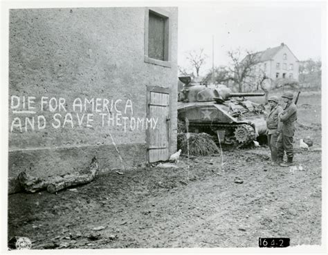 Us Army Soldiers Reading German Propaganda Graffitied On A Wall