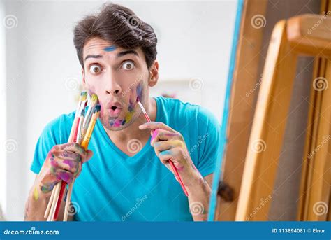 The Young Funny Artist Working On New Painting In His Studio Stock