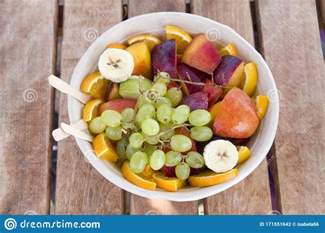 Fresh Bowl With Fruit Salad Of Grapes Peaches Oranges Banana And