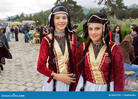 Two Happy Girls In Traditional Georgian Costumes Ready For Performance