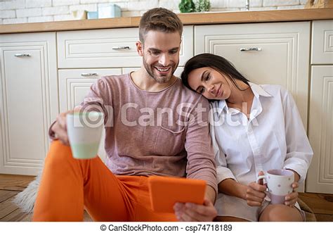 Wife Leaning On Shoulder Of Husband While Watching Movie On Tablet