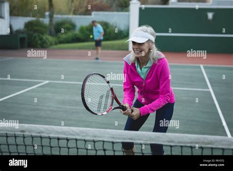 Senior Woman Playing Tennis In Tennis Court Stock Photo Alamy