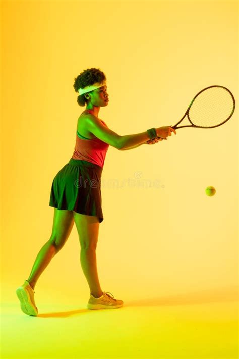 Vertical Image Of African American Female Tennis Player Hitting Ball In