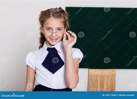 Schoolgirl With Glasses In Class At The School Board Stock Image