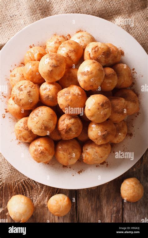 Greek Loukoumades Donuts With Honey And Cinnamon Close Up On A Plate Vertical View From Above