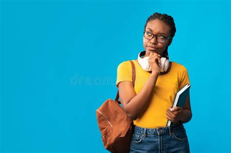 Thoughtful Black Student Girl Thinking Standing On Blue Studio ...