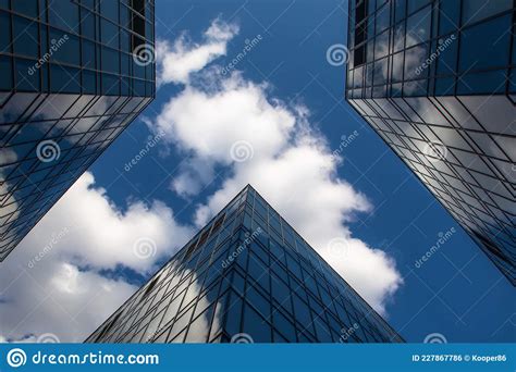 Beautiful Glass Buildings Against A Blue Sky With Clouds Modern