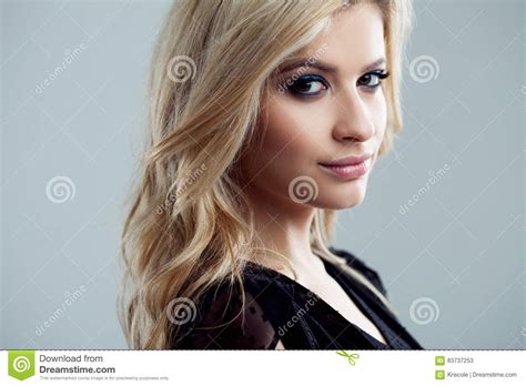 Young And Attractive Blonde Girl With Shiny Wavy Hair Beautiful Model Curly Hairstyle Stock
