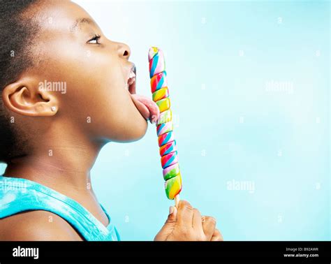 Young Girl Licking Lollipop Fotos Und Bildmaterial In Hoher Auflösung