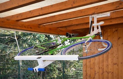 Pulley system allow easy lifting of bicycle. FLAT-BIKE-LIFT CEILING BIKE RACK