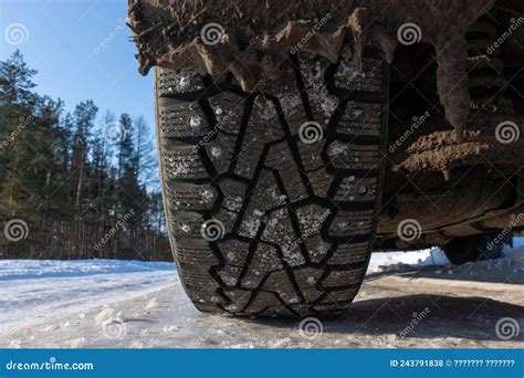 Winter Studded Tire Tread Standing In The Snowdrift Close Up After A