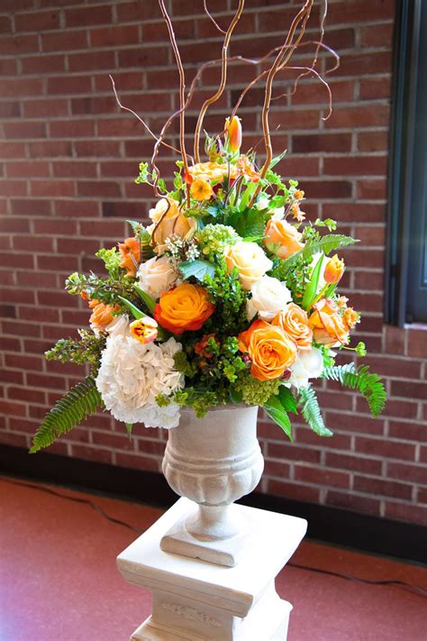 Simple wedding altar flower arrangement. citrus | Large flower arrangements, Artificial floral ...