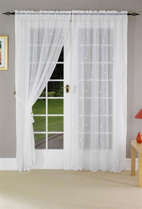 This minimally furnished room, featured on hgtv.com, is designed to feel spacious and airy through a neutral color palette and french doors french door curtains. But with curtain rod much higher and with maybe a roller ...