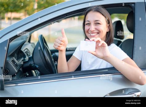 Young Woman Holding Driver License In Her Car Stock Photo Alamy
