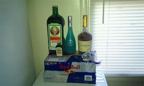 Three Bottles Of Alcohol Sitting On Top Of A Box Next To A Window Sill