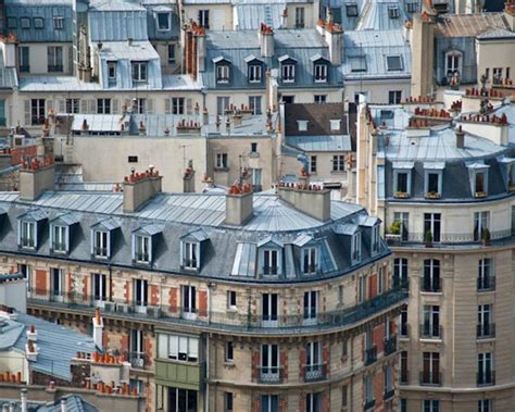 An Aerial View Of The Roofs And Windows Of Buildings In Paris With