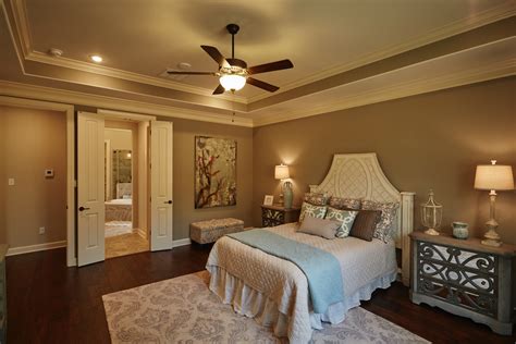 This bedroom is designed beautifully with a gray and beige color scheme accented by pops of royal blue. The master bedroom has a double-door entry to the master ...