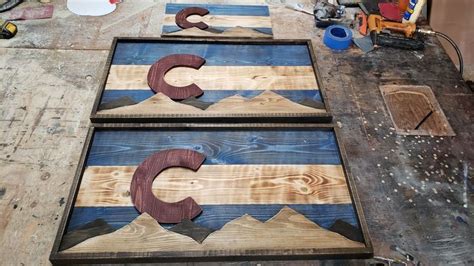 Two Wooden Letters Sitting On Top Of A Table Next To Other Woodworking