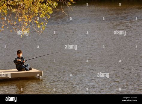 Boy Fishing Off Dock In Hi Res Stock Photography And Images Alamy