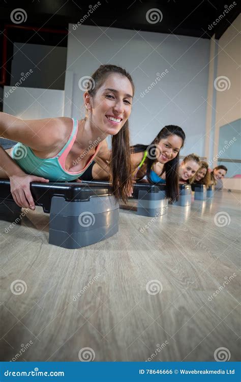 Group Of Women Exercising On Aerobic Stepper Stock Photo Image Of