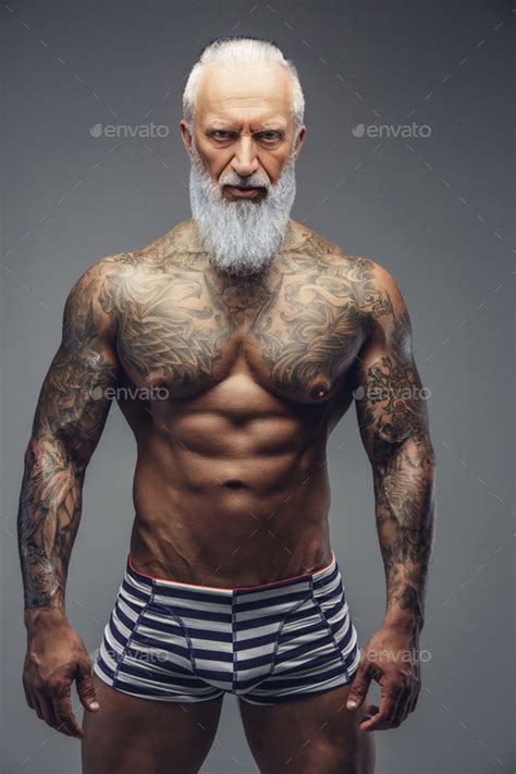 Naked Grandfather With Muscular Tattooed Body Isolated On Gray Stock