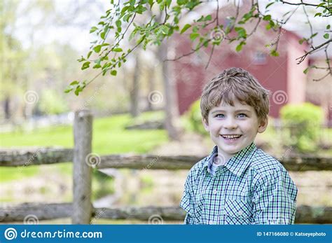 A held under these smothering waves. Boy On Farm Standing Under A Tree Stock Photo - Image of ...