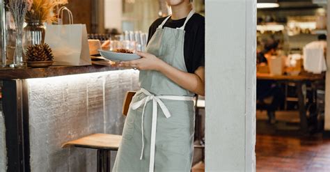 Confident Waitress In Apron With Plate · Free Stock Photo