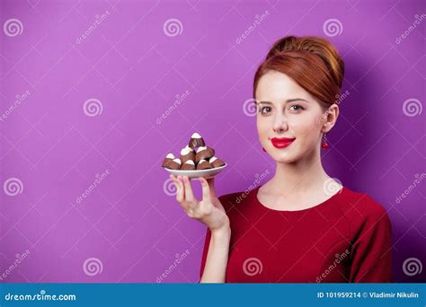 Photo Of Beautiful Young Woman With Plate Full Of Chocolate Candies
