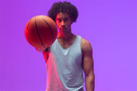 Image Of Biracial Basketball Player With Basketball On Neon Purple