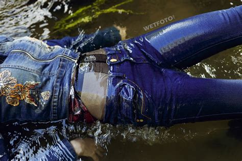 fully clothed girl in jacket jeans and tights get wet by the river