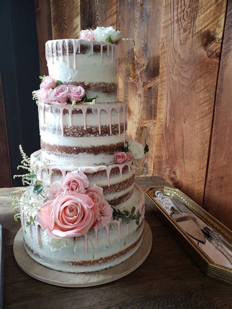 Stunning Tier Naked Wedding Cake With Pink Drip Frosting And Pink